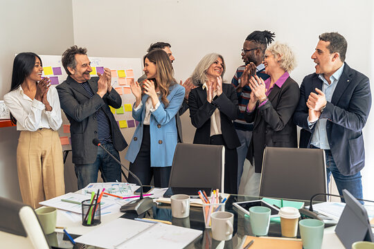 Creative multicultural business team laughing brainstorming session modern office diverse professional collaboration innovative planning