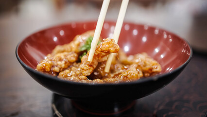 An exotic, Asian dish of fried chicken with curry sauce. Concept of traditional, Asian food and recipes.