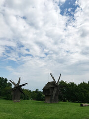Historic wooden windmills in a picturesque rural landscape. Chernivtsi, Ukraine.