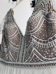 Elegant bridal gown with intricate beadwork and lace details