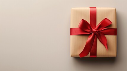 Close-up of a beautifully wrapped gift box with red ribbon on a plain background. Birthday, anniversary, special occasion,copy space,marketing,joy,  love, generosity,Christmas, Valentine’s Day