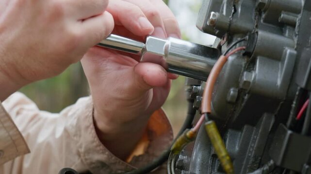 Boat outboard motor maintenance by an Australian Caucasian male. Outdoors, daytime, clip 2