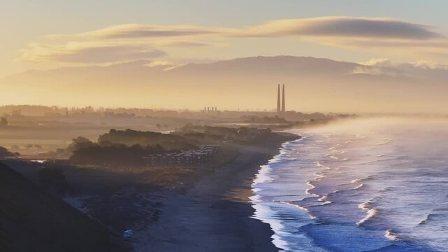Moss Landing Powerplant Twin Towers golden yellow sunrise morning mist seafog California aerial drone Sunset State Beach Pajaro Dunes Santa Cruz Manresa waves Monterey Bay Pacific Ocean upward