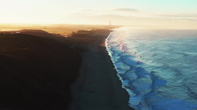 Sunrise early morning mist fog Moss Landing Powerplant Twin Towers Pajaro Dunes California aerial drone Santa Cruz surfer waves sand Monterey Bay Pacific Ocean Manresa Sunset State Beach static shot