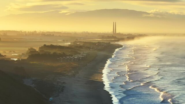 Moss Landing Powerplant Twin Towers warm golden sunrise morning mist seafog California aerial drone Sunset State Beach Pajaro Dunes Santa Cruz Manresa waves Monterey Bay Pacific Ocean static