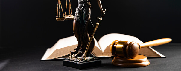 Judge gavel on a wooden desk, law books