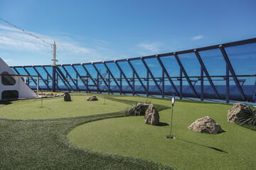 Minigolf mini golf course putting green on classic luxury cruiseship cruise ship liner for adult...