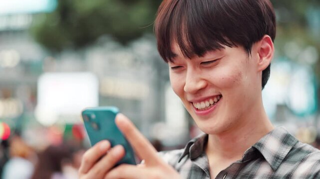 Man, typing and laughing with phone in city for online networking, funny text message and email response. Japanese person, smartphone and happy with internet meme, social media joke and communication
