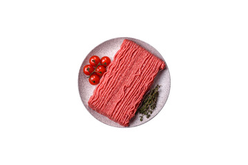 Raw ground beef or pork with salt, spices, herbs and tomatoes