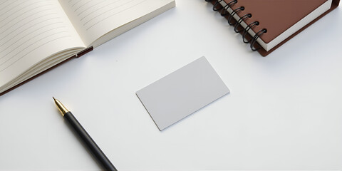 Blank gray business card on a clean tabletop with notebooks