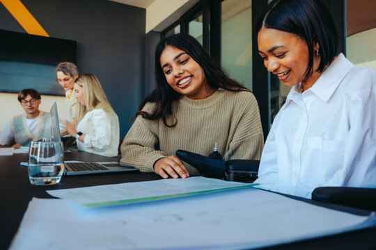 Diverse group of undergrad students collaborating in a modern college classroom setting