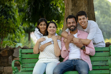 Portrait of happy Indian Family looking towards the camera with copy space