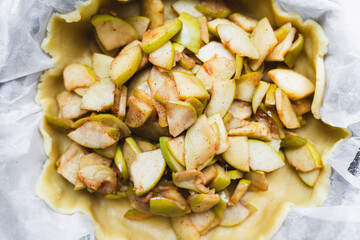 fall recipe preparation process of half-open apple pie with autumn leaves decor