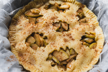 fall recipe preparation process of half-open apple pie with autumn leaves decor