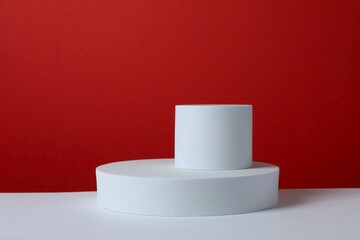 White podiums on color background 