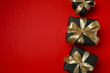 Beautiful gift boxes tied with bows on color background 