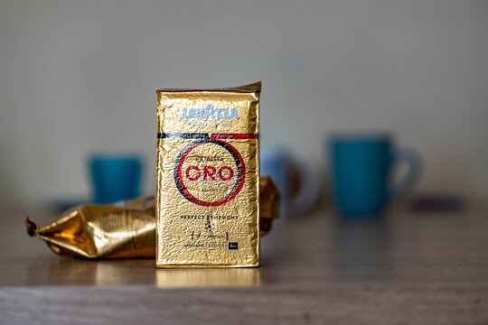 Italian Lavazza brand coffee Oro in a package standing on a table with blurred background
