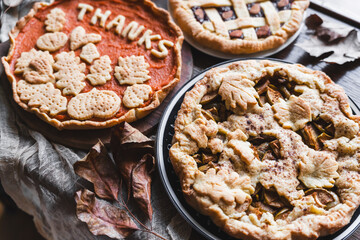 fall recipe preparation process of half-open apple pie with autumn leaves decor