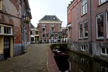 Houses with a water canal and boat in the old town of Alkmaar in the Netherlands