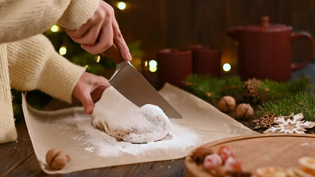 Sliced of Christmas stollen on wooden background. Traditional Christmas festive pastry dessert. Stollen is treat for Christmas