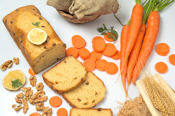 Carrot cake with chocolate chips, walnuts and lemon on white background