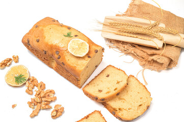 Carrot cake with chocolate chips, walnuts and lemon on white background