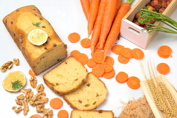 Carrot cake with chocolate chips, walnuts and lemon on white background