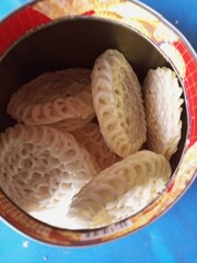 White crackers are a traditional Indonesian snack made from starch or rice flour, with a light and crunchy texture. Its flat shape and usually white color makes it unique and easy to recognize.