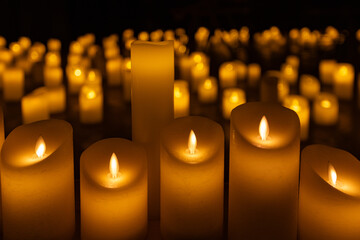 blurred symphonic orchestra on stage with lots of candles