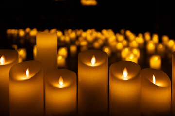 blurred symphonic orchestra on stage with lots of candles