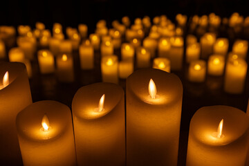 blurred symphonic orchestra on stage with lots of candles