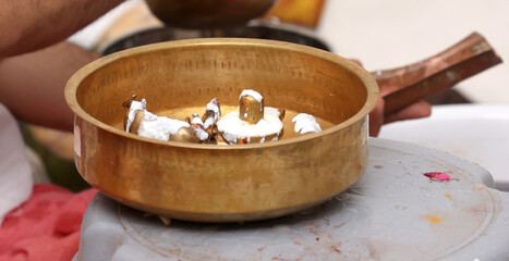 Performing Pooja for Hindu god siva linga with milk, honey and coconut water	
