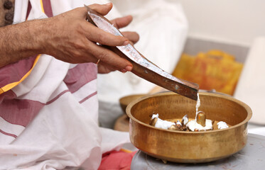Performing Pooja for Hindu god siva linga with milk, honey and coconut water	
