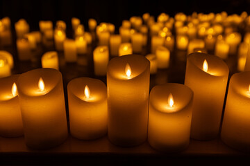 blurred symphonic orchestra on stage with lots of candles