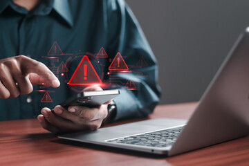Person use smartphone and laptop with spam virus on warning caution for notification on internet...