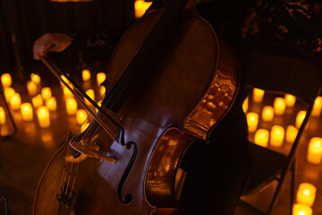 closeup of cello with lots of candles © Ruslan