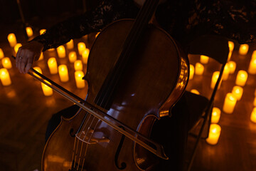 closeup of cello with lots of candles