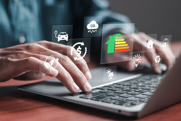 Energy efficiency concept. Businessman use laptop with energy efficiency rating system on virtual...