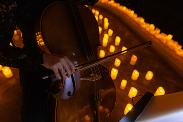closeup of cello with lots of candles