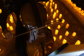 closeup of cello with lots of candles © Ruslan