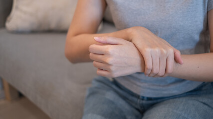 Woman female suffering from wrist sprain arthritis inflammation from physical injury problem