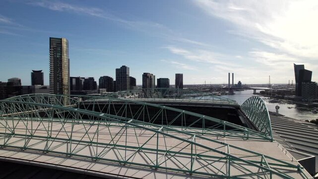 Roof trestles in major sports stadium, close-up drone shot.