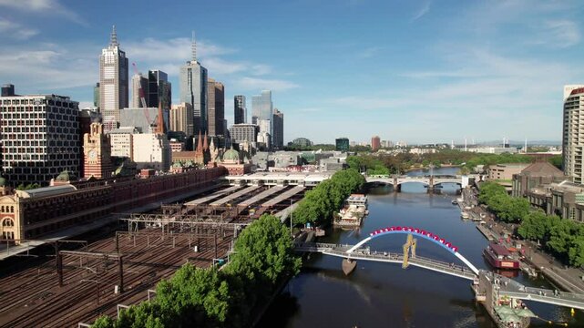 Prince's Bridge and Flinders Street Railway Station, quality aerial shot of Melbourne Central Business District, 4K