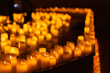 blurred symphonic orchestra on stage with lots of candles
