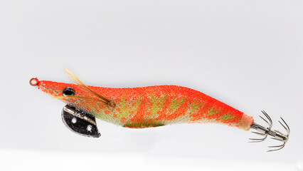 An Egi ,in this picture predominantly red color, its a fake lure for squid and cuttlefish a fishing lure for casting and spinning.