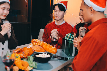 Group of young Asian man and women as friends having fun at a New Year's celebration, holding gift...