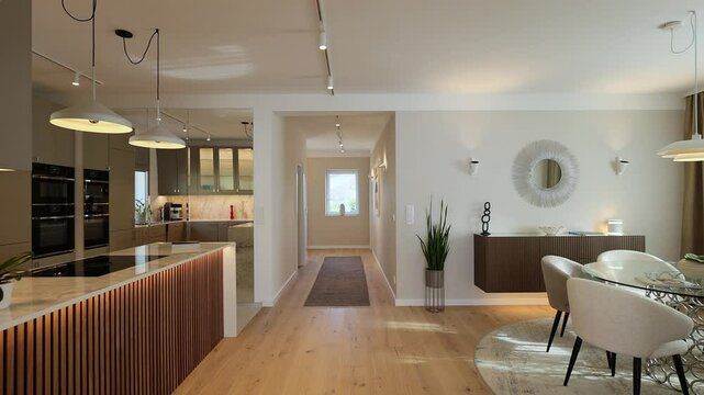 Interior tracking shot of real estate house with modern luxury dining room and kitchen