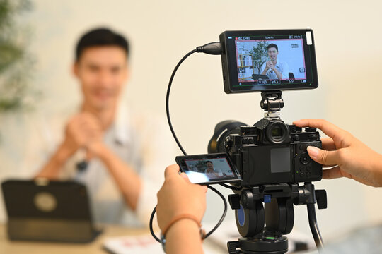 Close up of a camera filming interview of a successful entrepreneur in his office