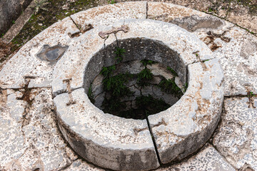 Close-up of an ancient stone well (Well of fair dances). Historical and archaeological site of...
