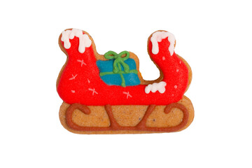 Homemade gingerbread colored cookie „Sleigh with gift bag“ on white, isolated Christmas handmade gingerbread cookie „Sleigh with gift bag“ on white background, Christmas dessert, top view, flat lay